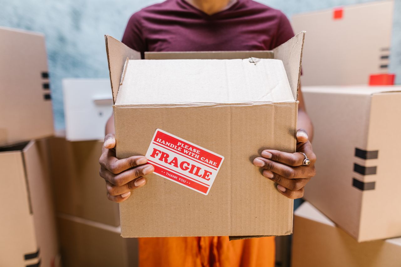 Mover holding a box marked Fragile, handled with care