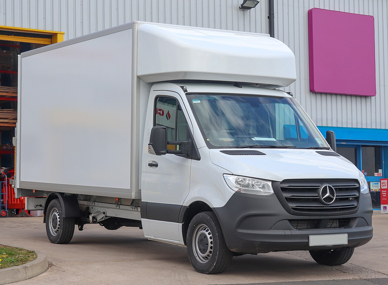 White Mercedes-Benz Sprinter Luton van with its box body overhanging the cab